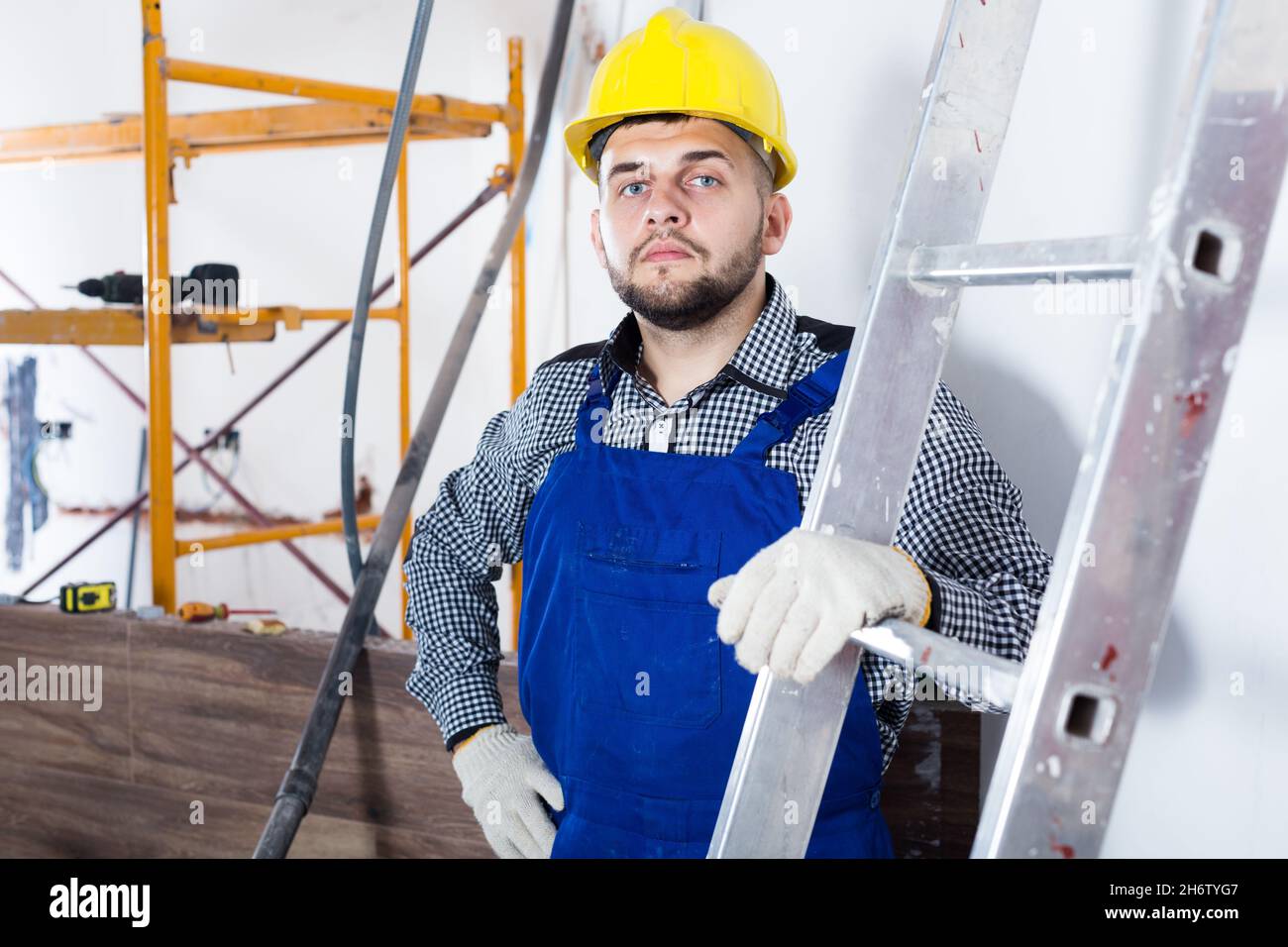 Portrait of smiling workman which is doing repair Stock Photo Alamy