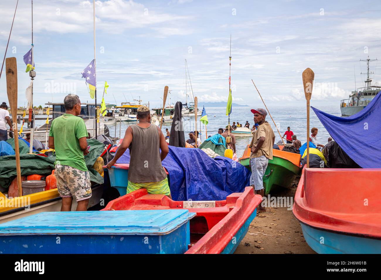 HONIARA, SOLOMON ISLANDS - Nov 10, 2016: People milling amongst boats lined up on the shoreline at Point Cruz Yatch Club in Honiara, the capital city Stock Photo