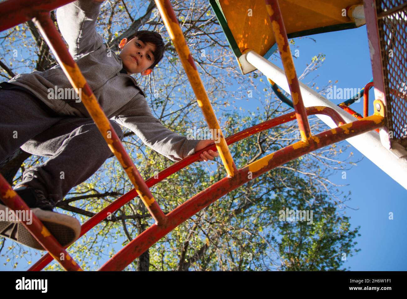 Caucasian young boy playing in the playground Stock Photo - Alamy