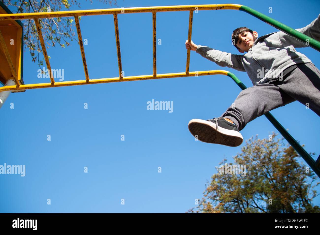 Caucasian young boy playing in the playground Stock Photo - Alamy