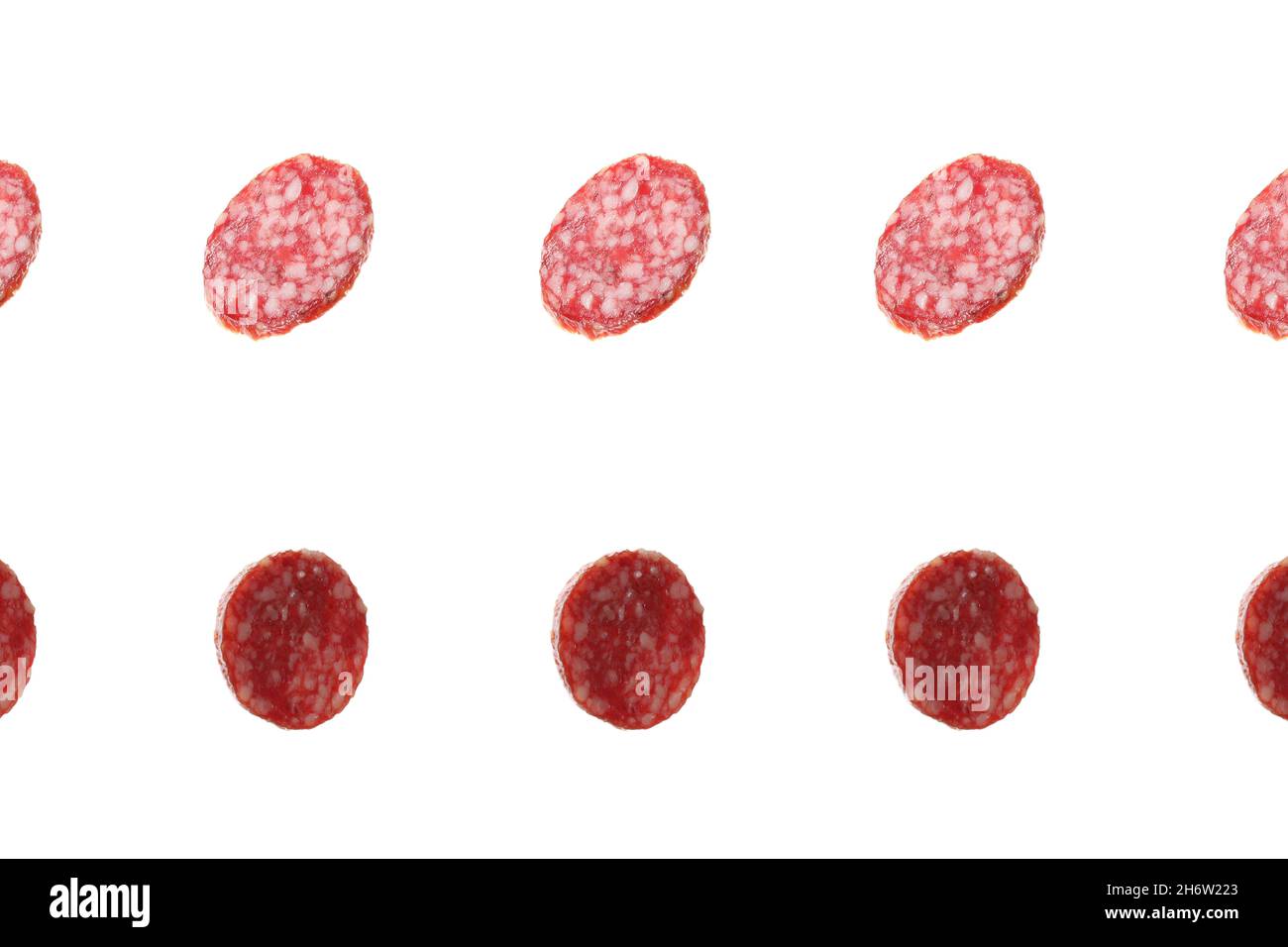 Falling salami sausage isolated on white background Stock Photo