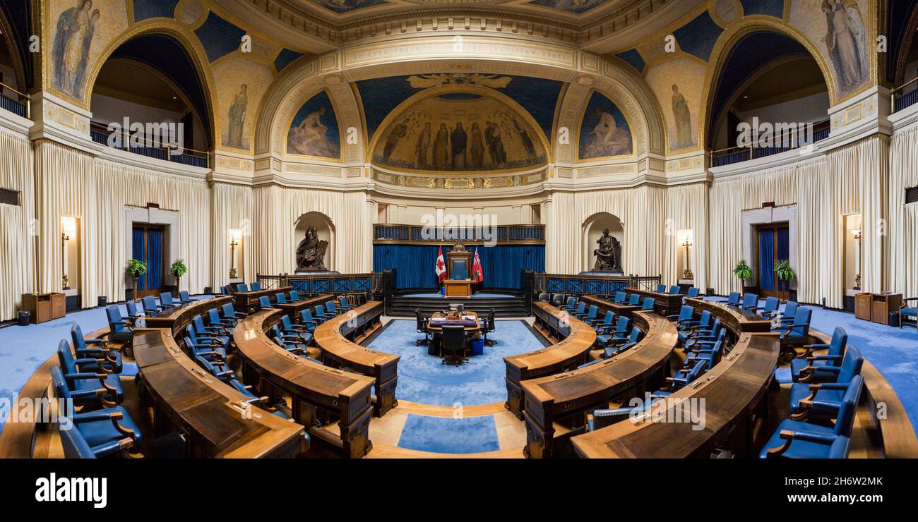 Interior of the Legislative Assembly of Manitoba. The benches, tables, and flags Stock Photo