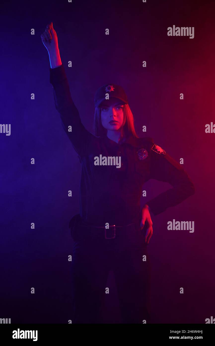 Red Color Police Redheaded female police officer is posing for the camera against a ...