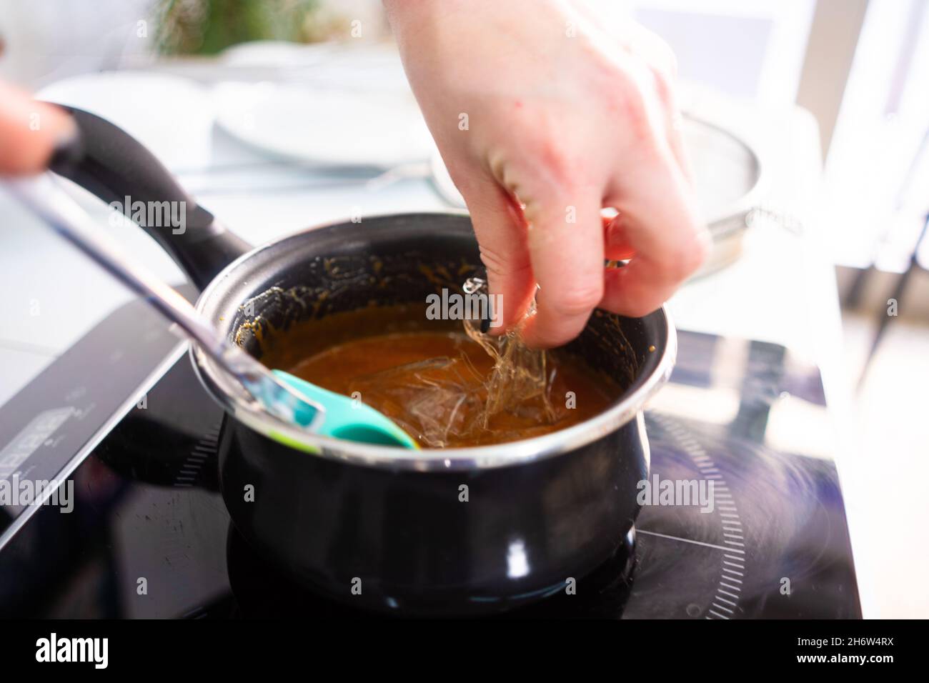 Pastry maker making chocolate for making the cake. Stock Photo