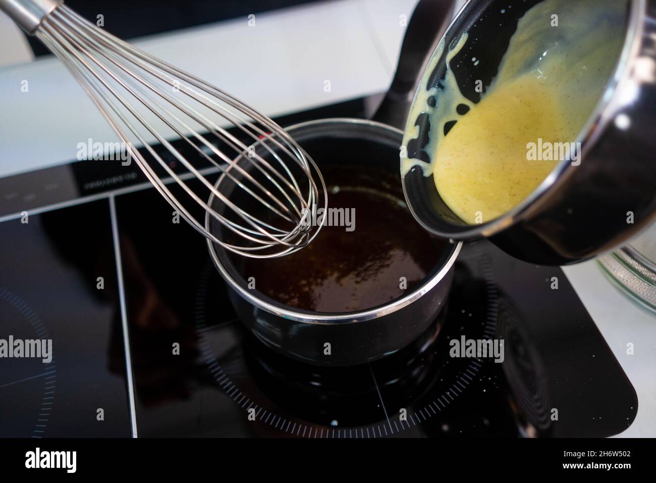 Pastry maker making chocolate for making the cake. Stock Photo