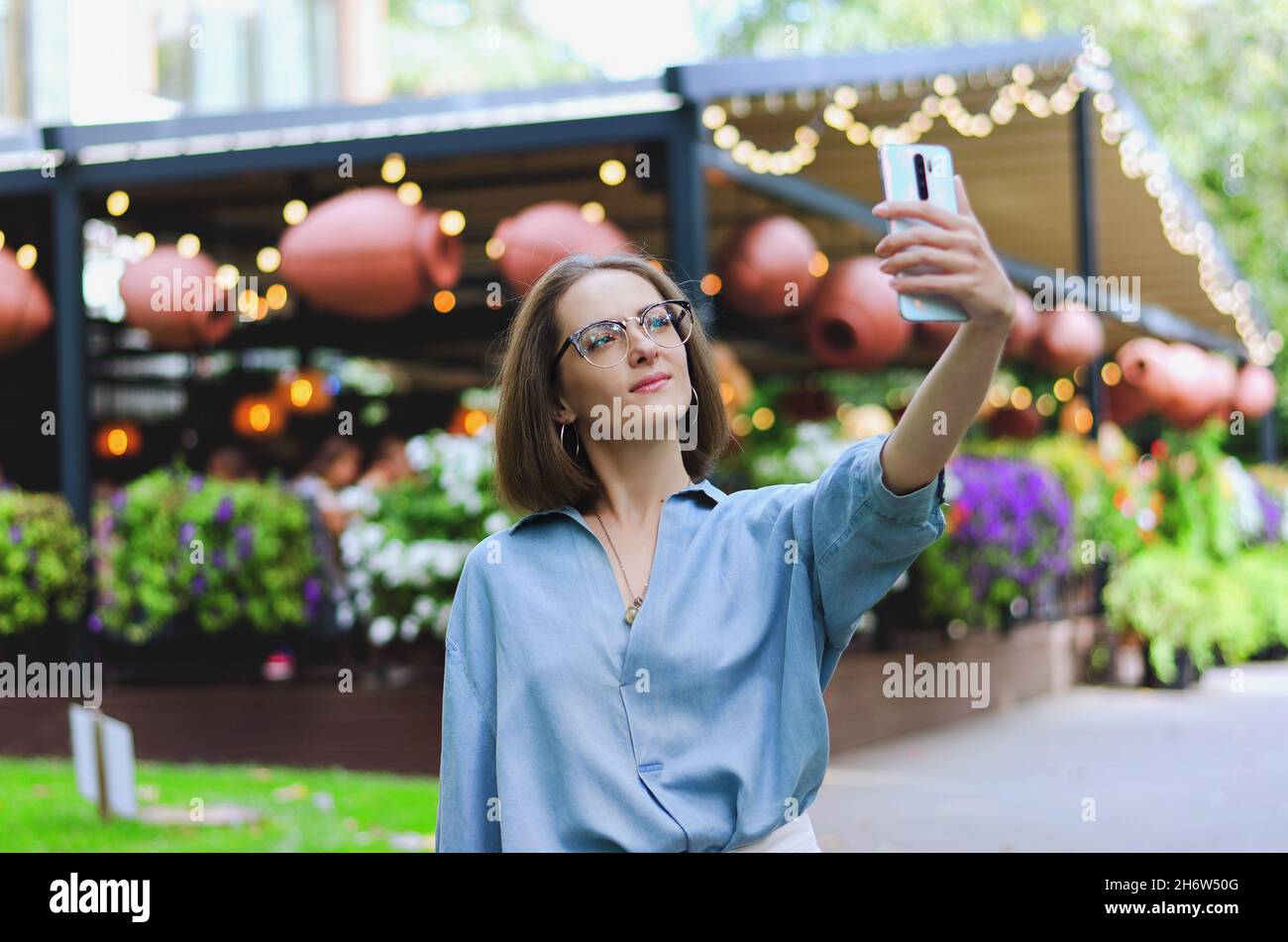 Urban portrait of young elegant business woman in eye glasses and ...