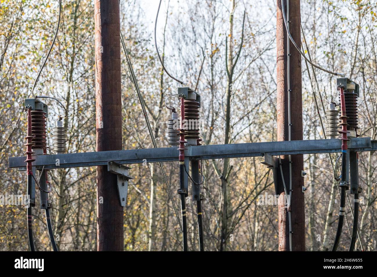 33KV overhead electrical supply mounted onto wooden poles connection to an underground supply cable. Stock Photo
