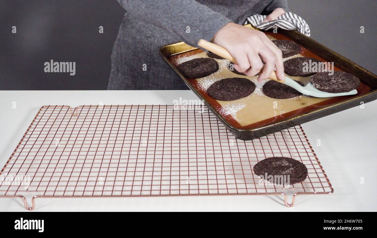 Step by step. Cooling freshly baked chocolate cookies on a wire rack ...
