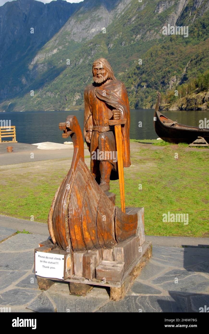 Wooden carving on public display, Gudvangen Fjordtell, Norway, with mountains beyond Stock Photo