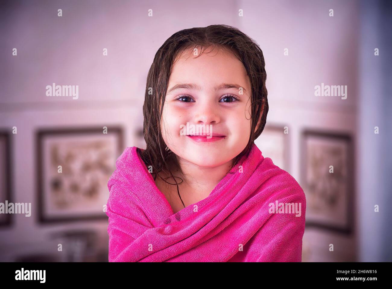 Portrait of little girl wearing towel after taking a shower. Childhood