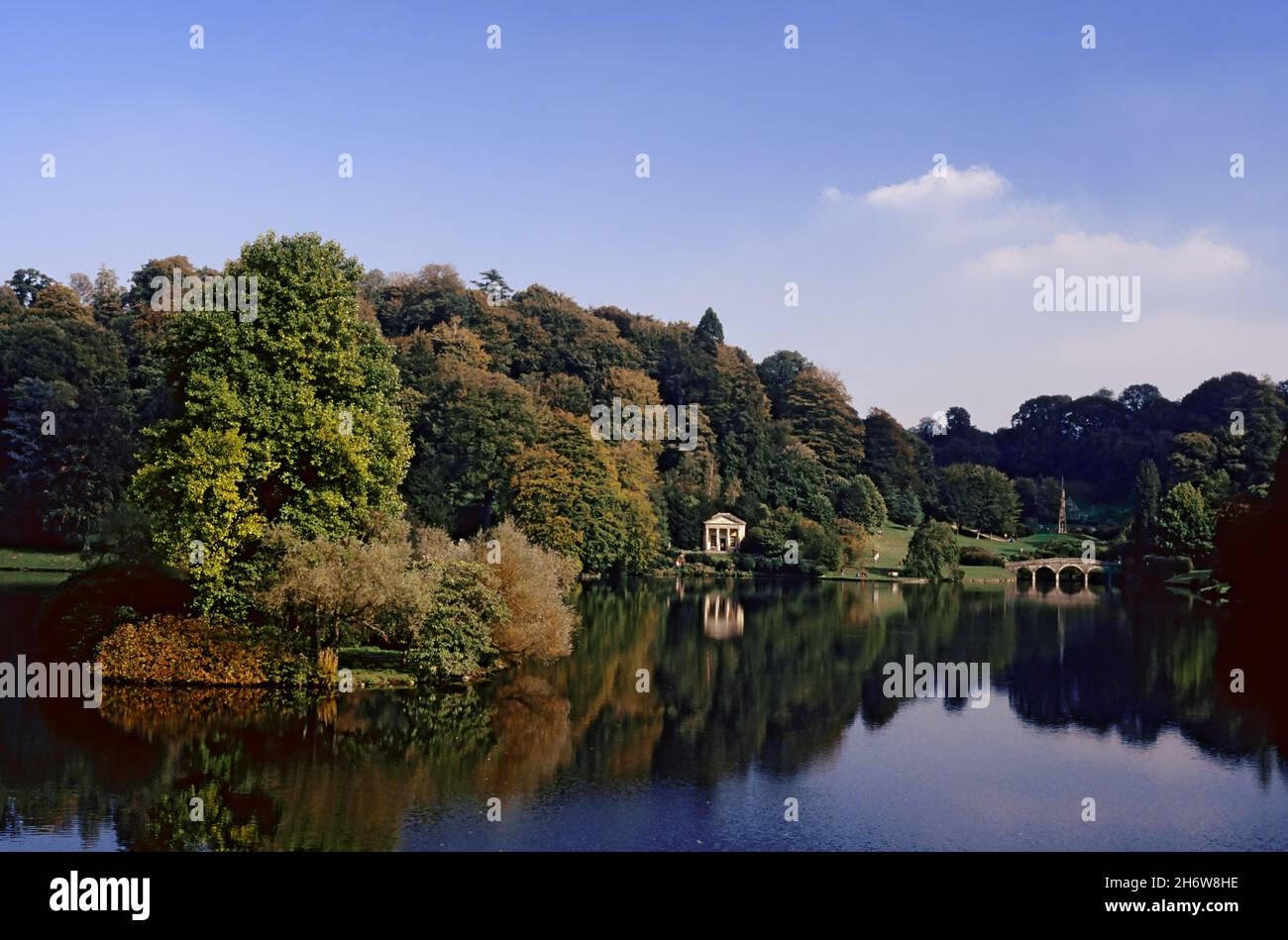 Stourhead Garden, Wiltshire, England, UK, showing the lake, C18th Palladian bridge, the Temple of Flora and the Bristol Cross.  Transparency film photograph from 1992. Stock Photo