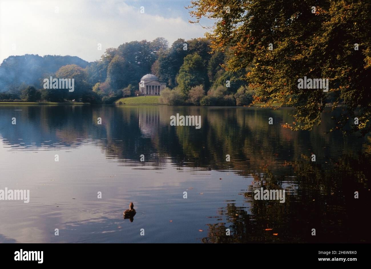 Autumn colour at Stourhead Garden, Wiltshire, England, UK, showing the Pantheon, designed by Henry Flitcroft and built in 1753, on the opposite bank.  Transparency film photograph from 1992. Stock Photo