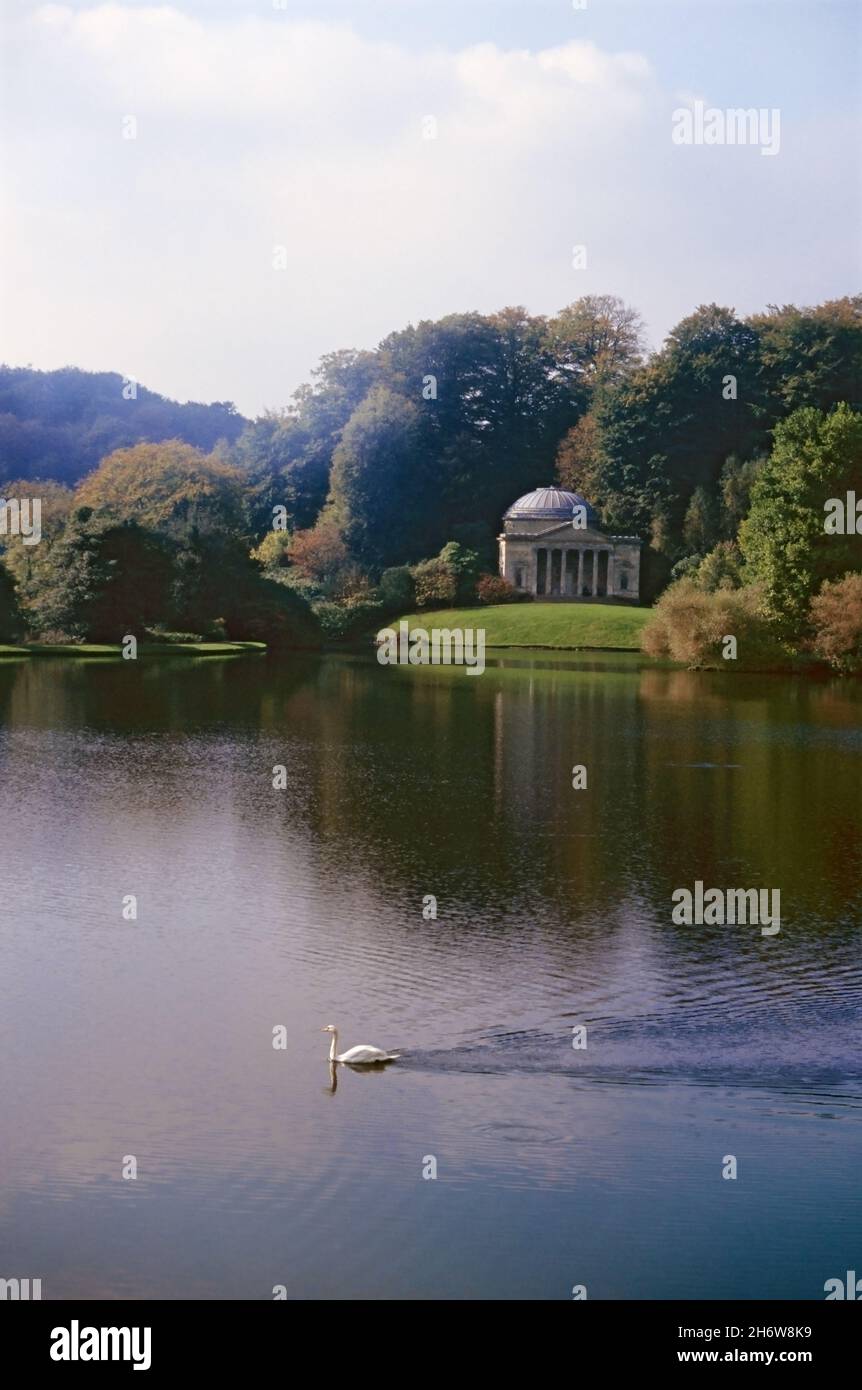 Autumn colour at Stourhead Garden, Wiltshire, England, UK, showing the Pantheon, designed by Henry Flitcroft and built in 1753, on the opposite bank.  Transparency film photograph from 1992. Stock Photo
