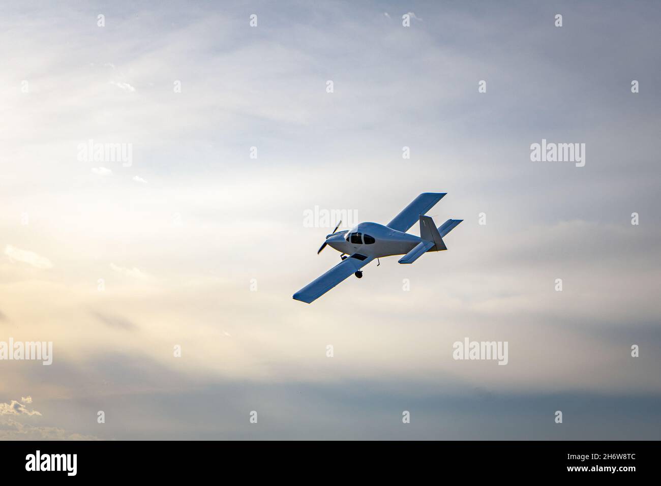 Small modern private jet in the sky. Stock Photo