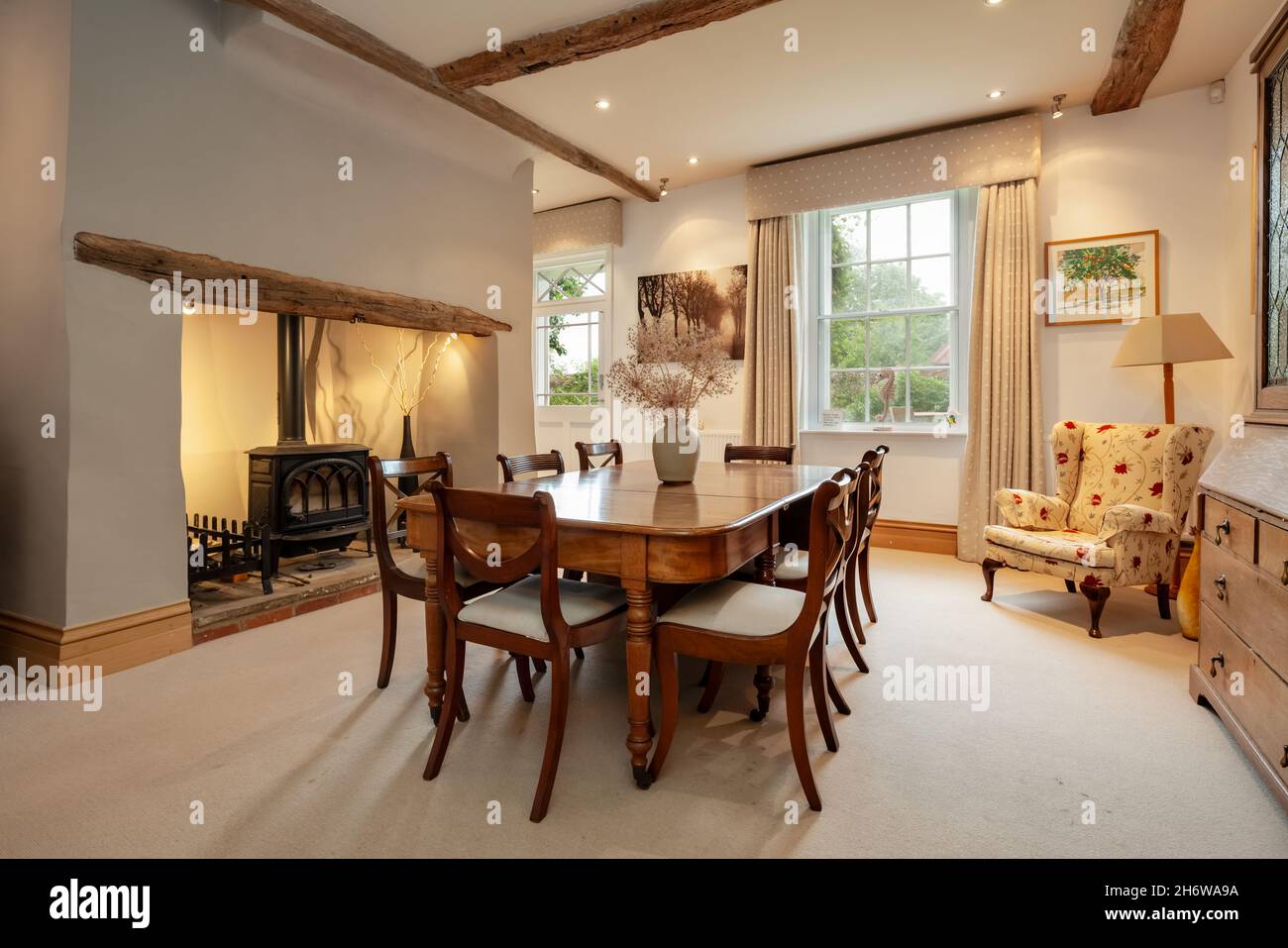 Wimbish, England - July 30 2019: Dining room in English period home decorated in a sympathetic modern manner with neutral colour scheme. Stock Photo