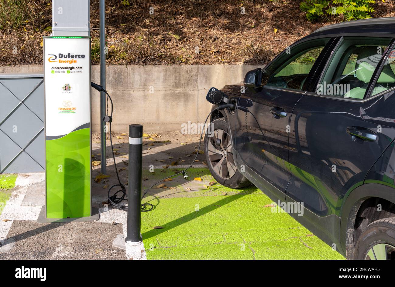 Bra, Cuneo, Piedmont, Italy - October 28, 2021: car in charge at the Electric Car Charging Station, of the company Duferco Energia, in Montenero stree Stock Photo