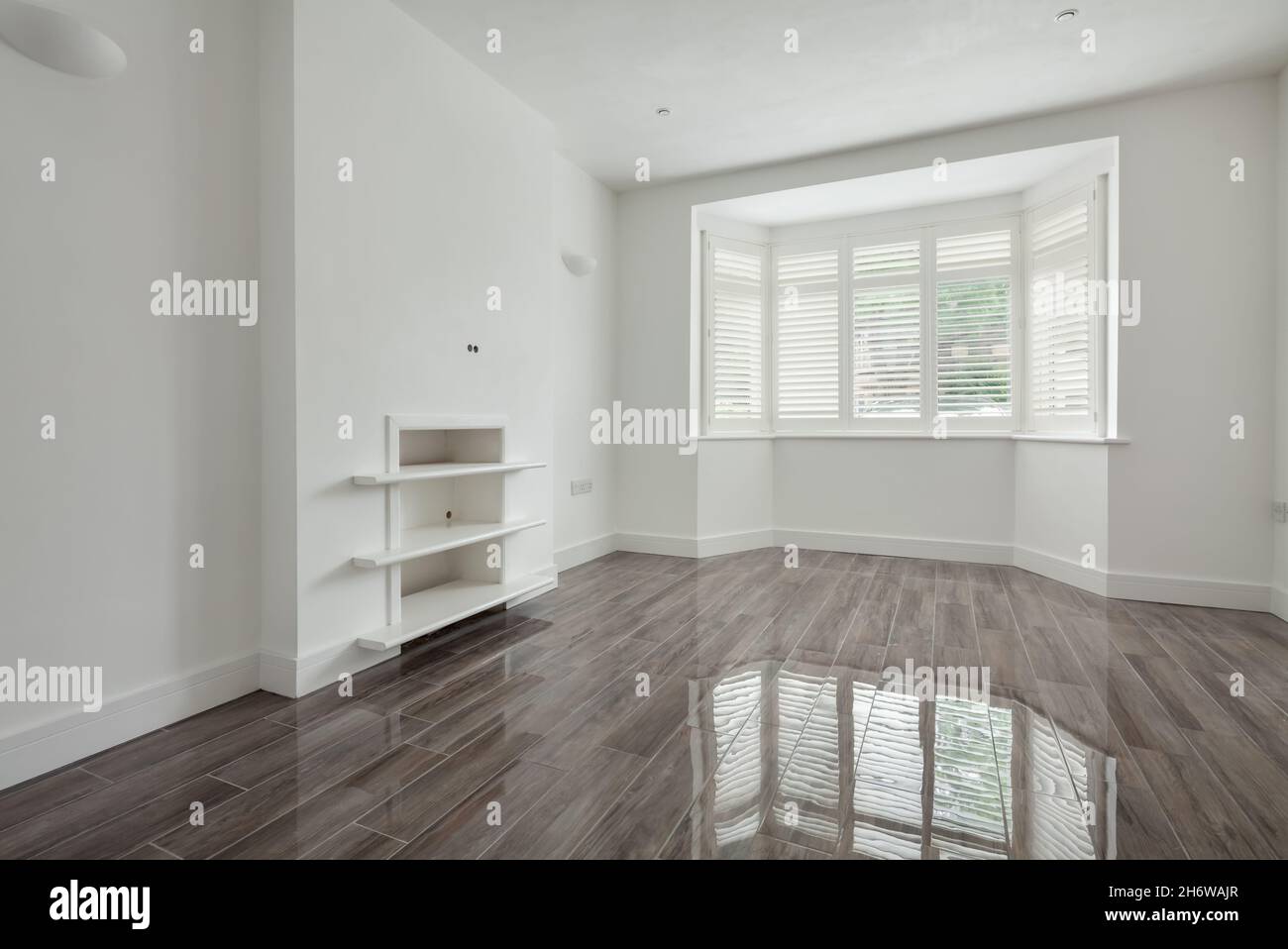 Cambridge, England - July 31 2019: Lounge with gloss ceramic tiled floor in newly renovated vacant home Stock Photo