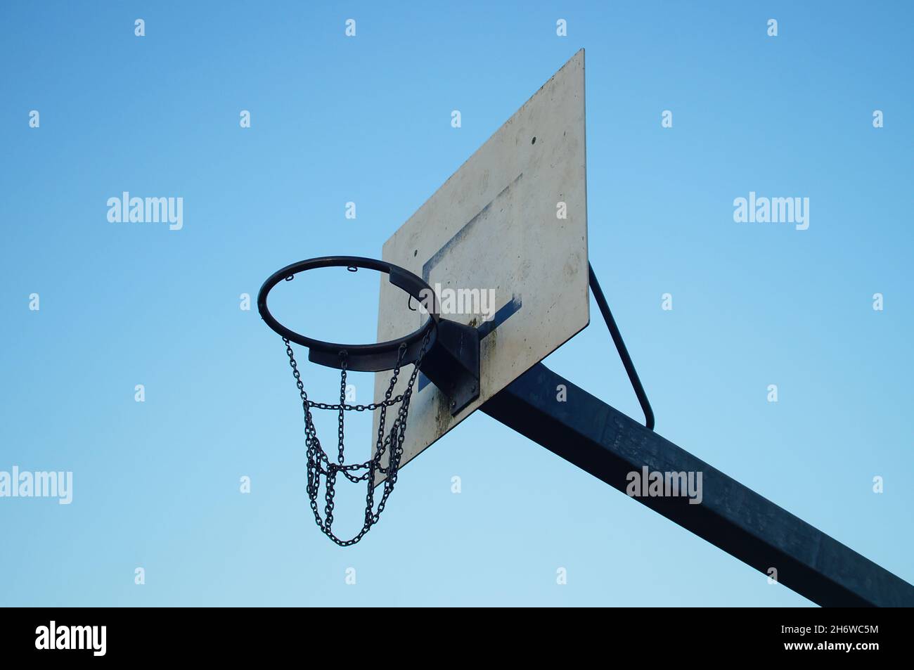 A worn basketball hoop in a public recreational area Stock Photo Alamy