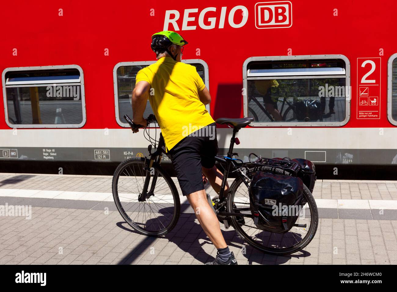 Man bike train station platform Germany Europe Healthy lifestyle Stock Photo