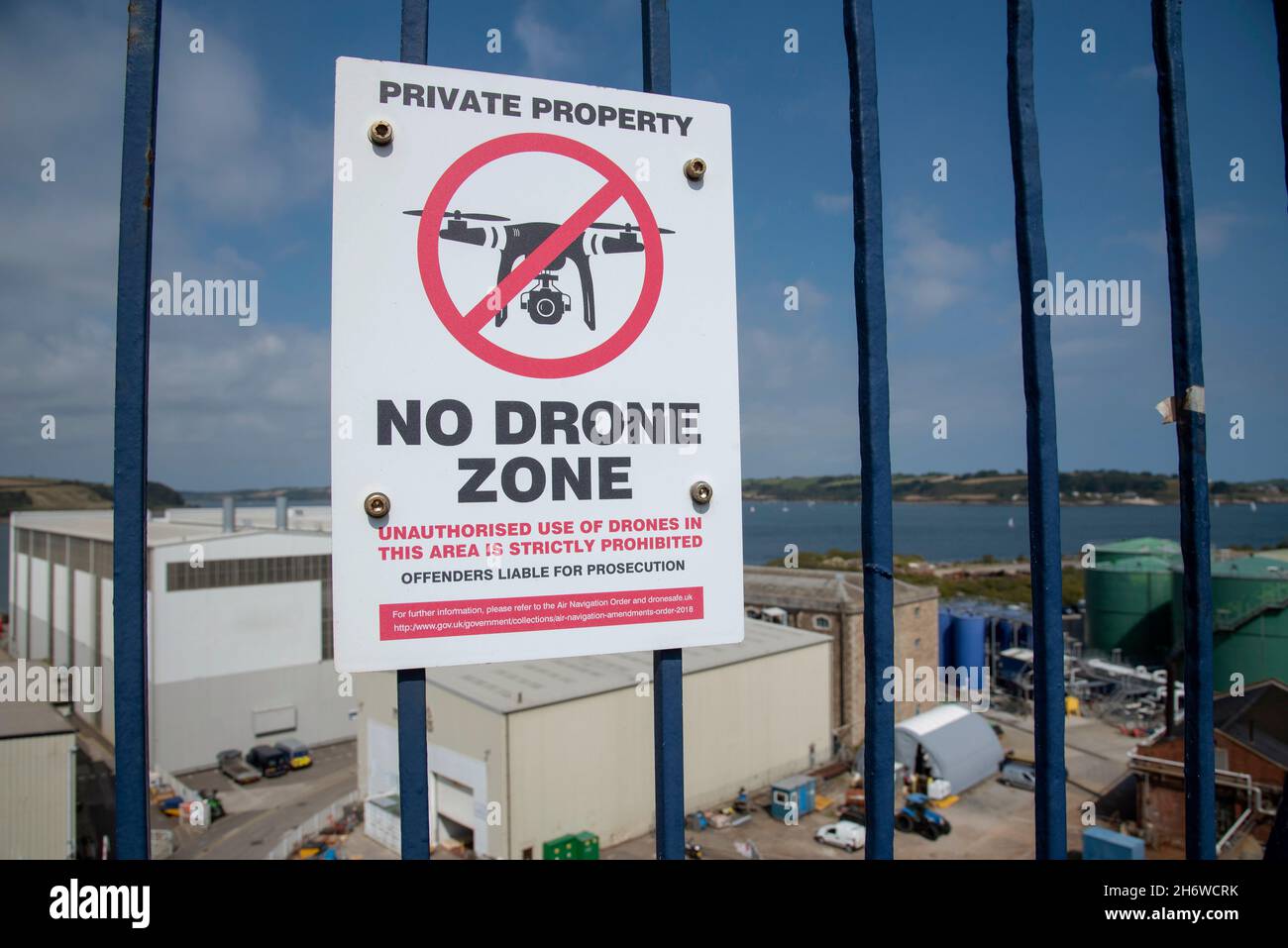 Cornwall, England, UK. 2021.  No Drone Zone sign on railings outside an industrial area. Stock Photo