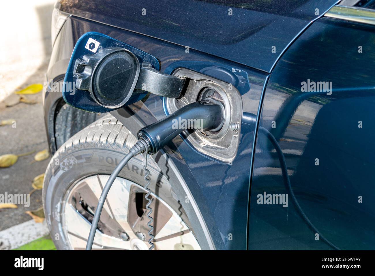 Bra, Cuneo, Piedmont, Italy - October 28, 2021: car in charge at the Electric Car Charging Station Stock Photo