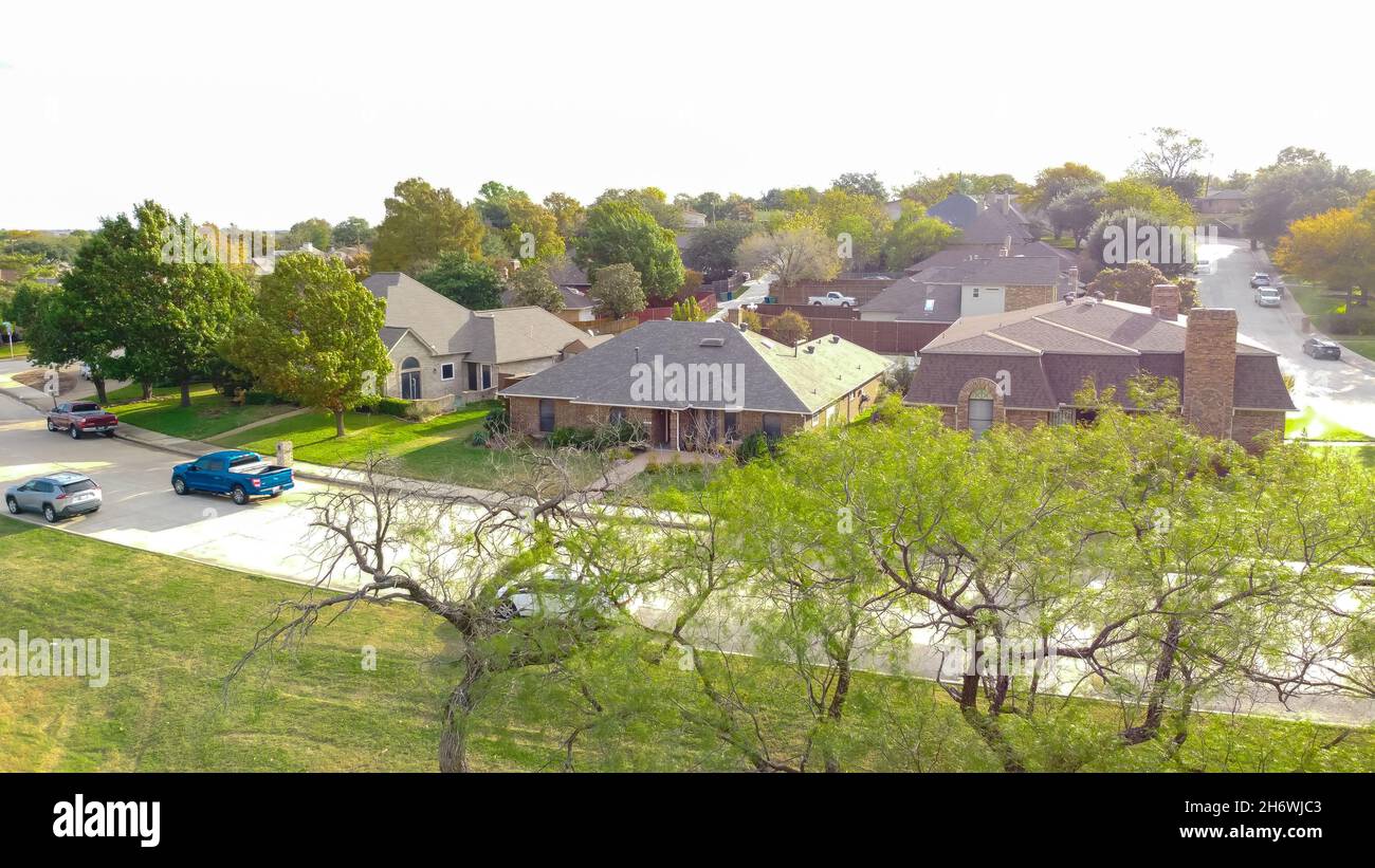 Aerial view Parkside house with parked cars on street in Carrollton