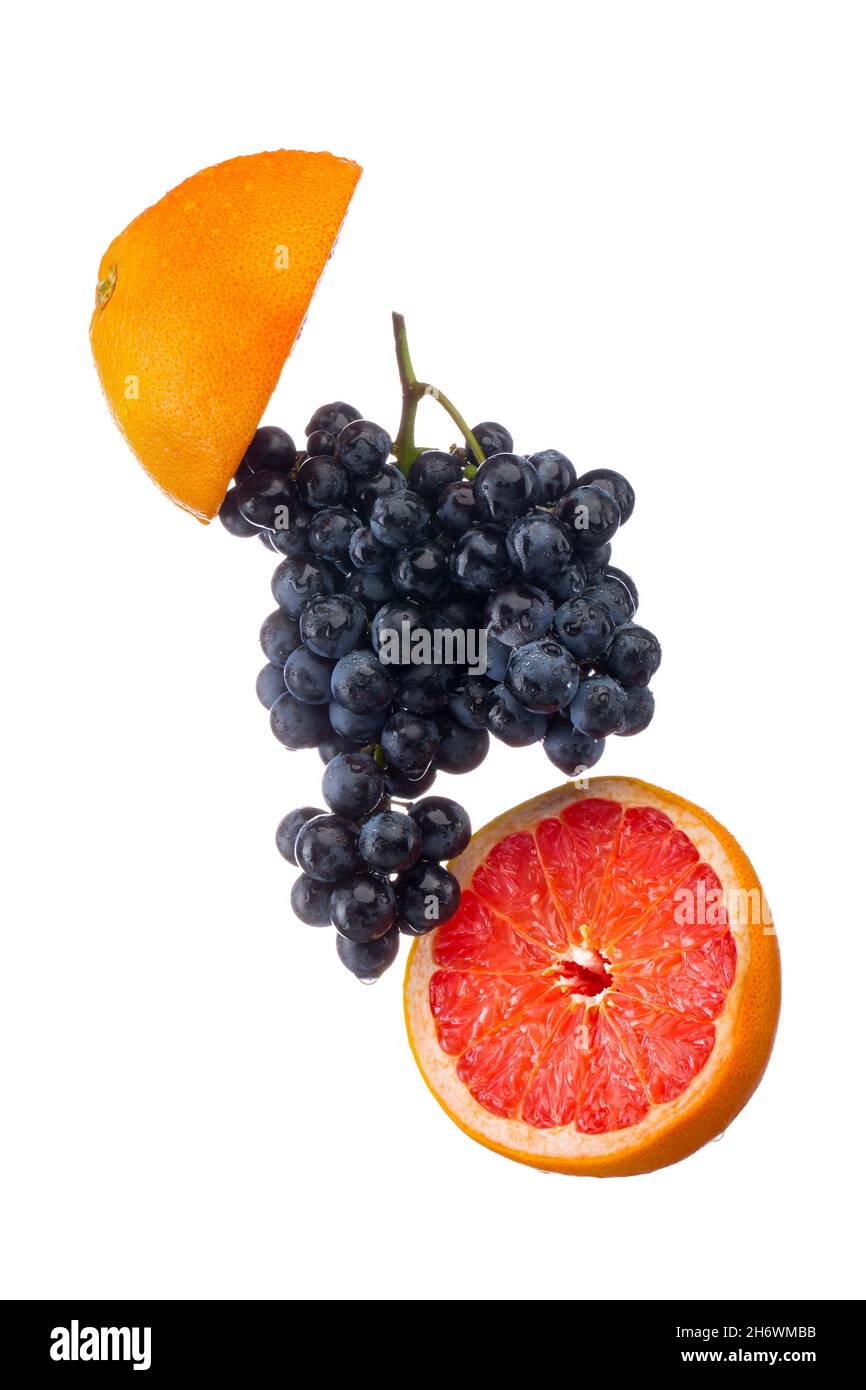 Dark blue grape with red grapefruit isolated on white background Stock Photo