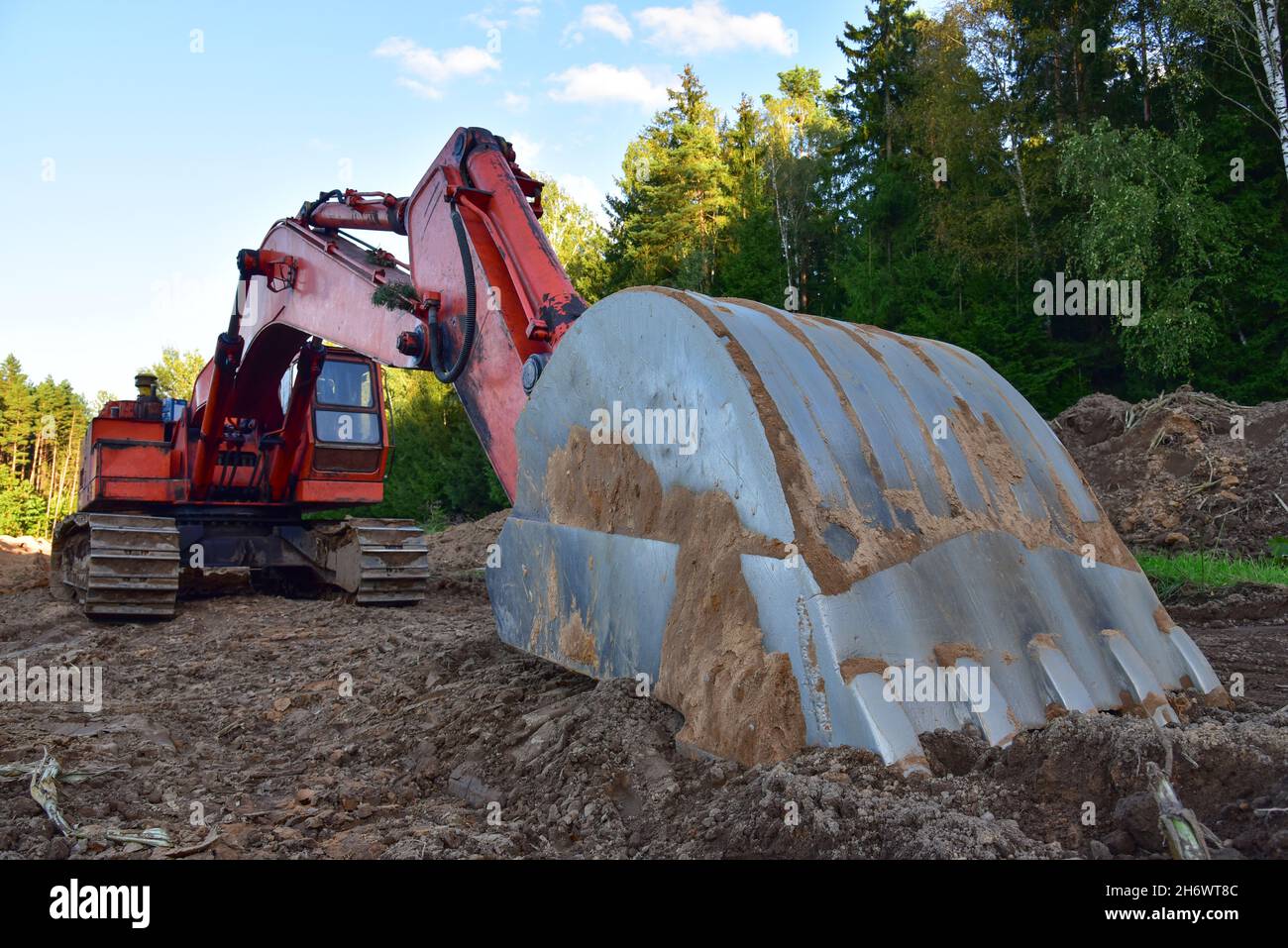 Excavator during groundwork at forest area for construction new road