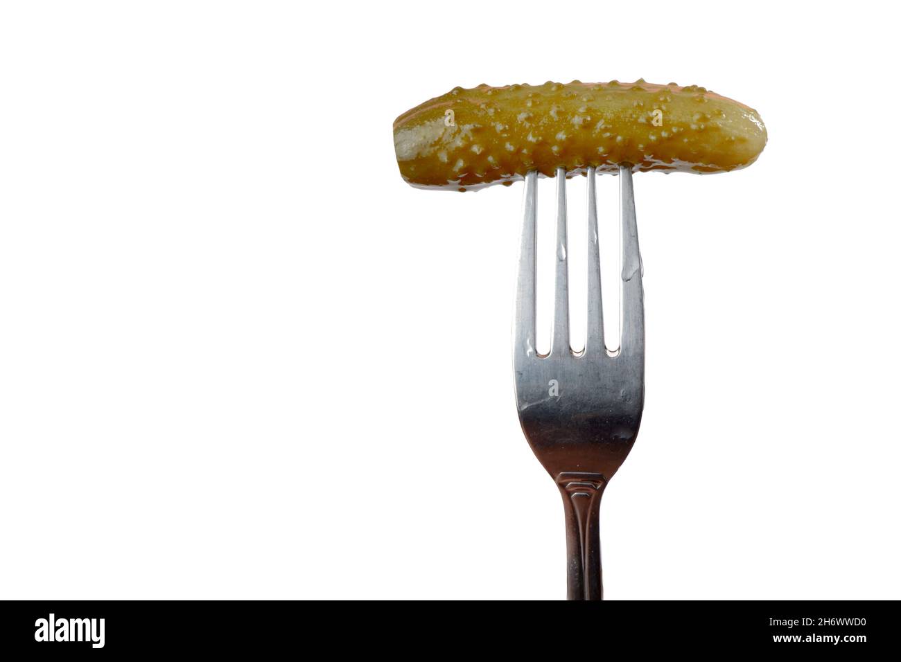 pickled cucumber on a fork isolated on a white background Stock Photo