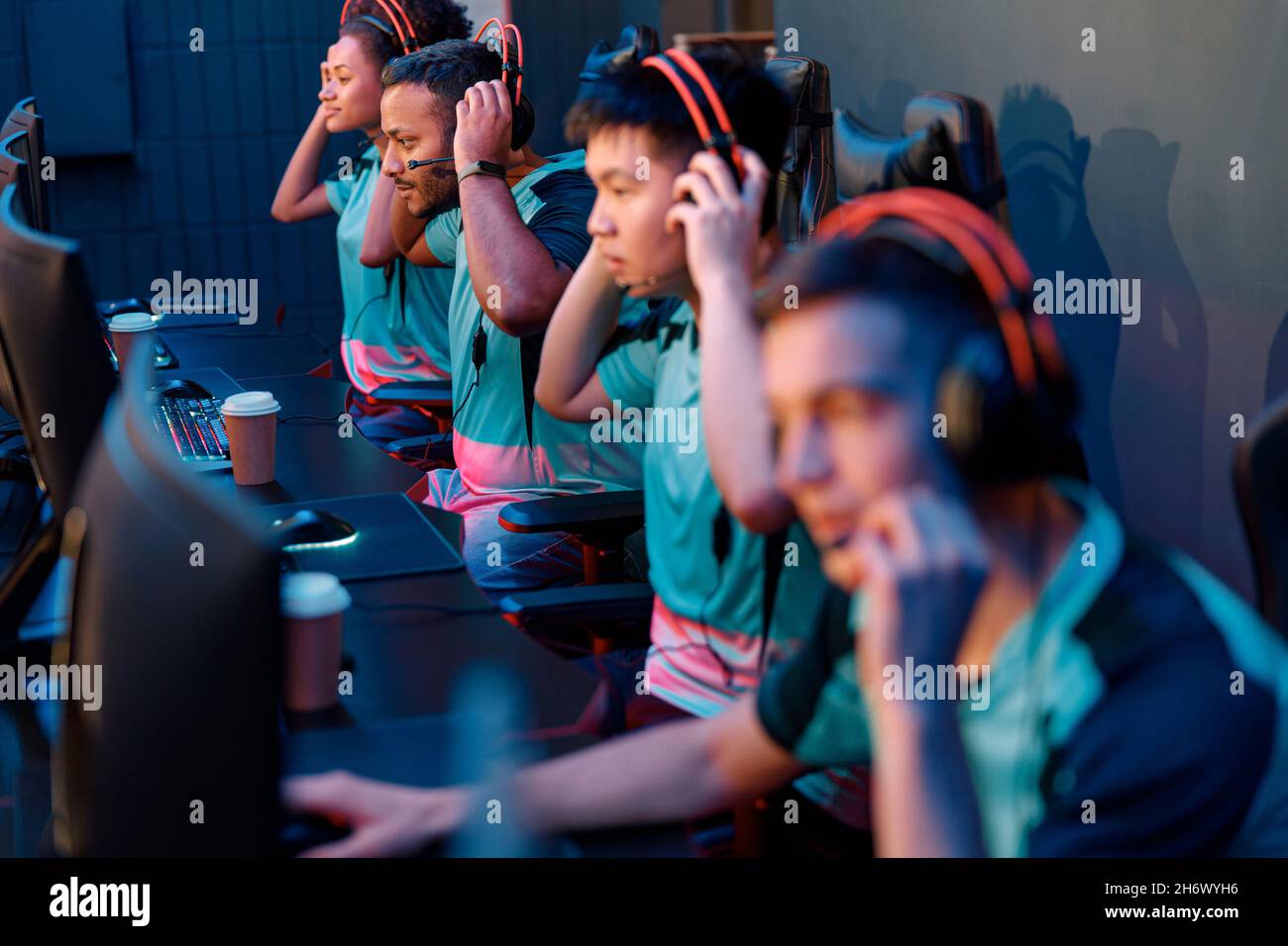 Team of professional gamers playing on pc in gaming club Stock Photo