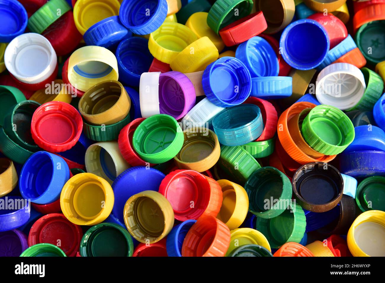 Plastic bottle caps background. Cap material is recyclable.Remove lids from  plastic bottles before recycling them. Recycling collection and processing  Stock Photo - Alamy