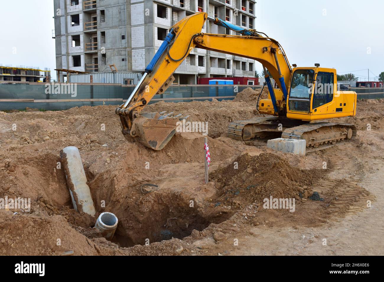 Excavator dig the trenches at a construction site. Trench for laying
