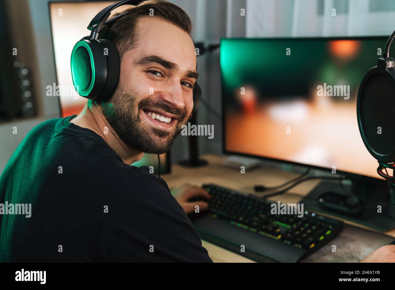 Free Photo  Player winning video games with controller and headset in  front of monitor. man using joystick and headphones, playing online games  on computer. person celebrating game win for leisure.