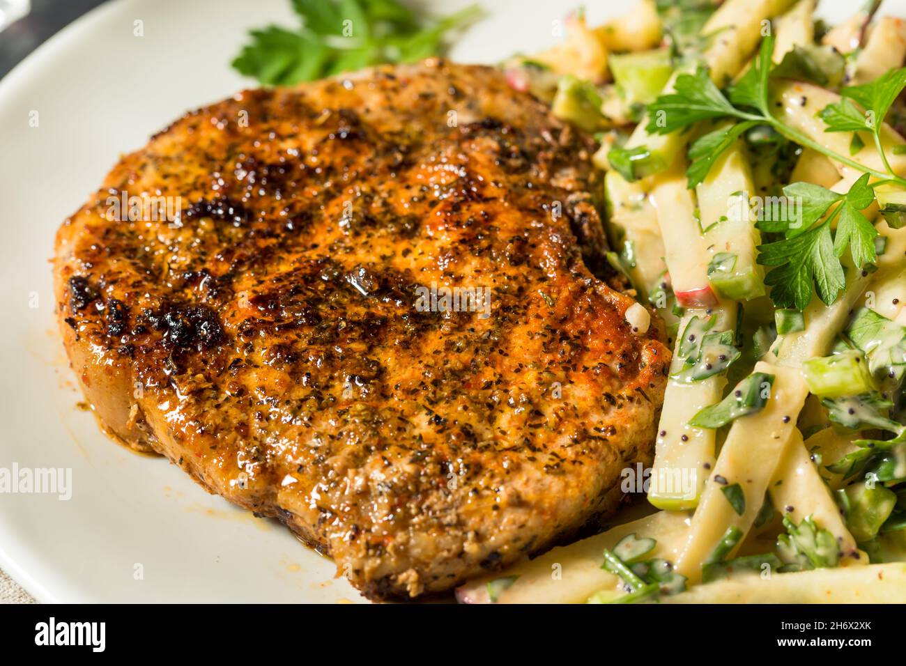 Homemade Roasted Pork Chop with Apple Slaw and Parsley Stock Photo