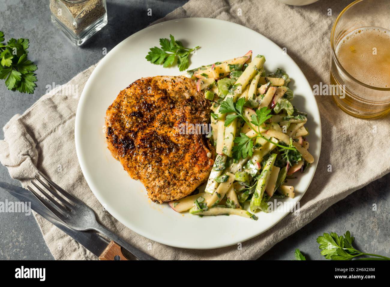 Homemade Roasted Pork Chop with Apple Slaw and Parsley Stock Photo