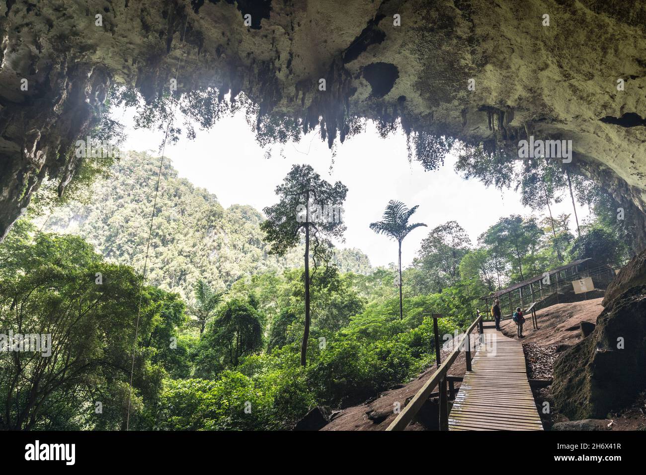 People on the boardwalk entrance to Niah cave, Malaysia Stock Photo