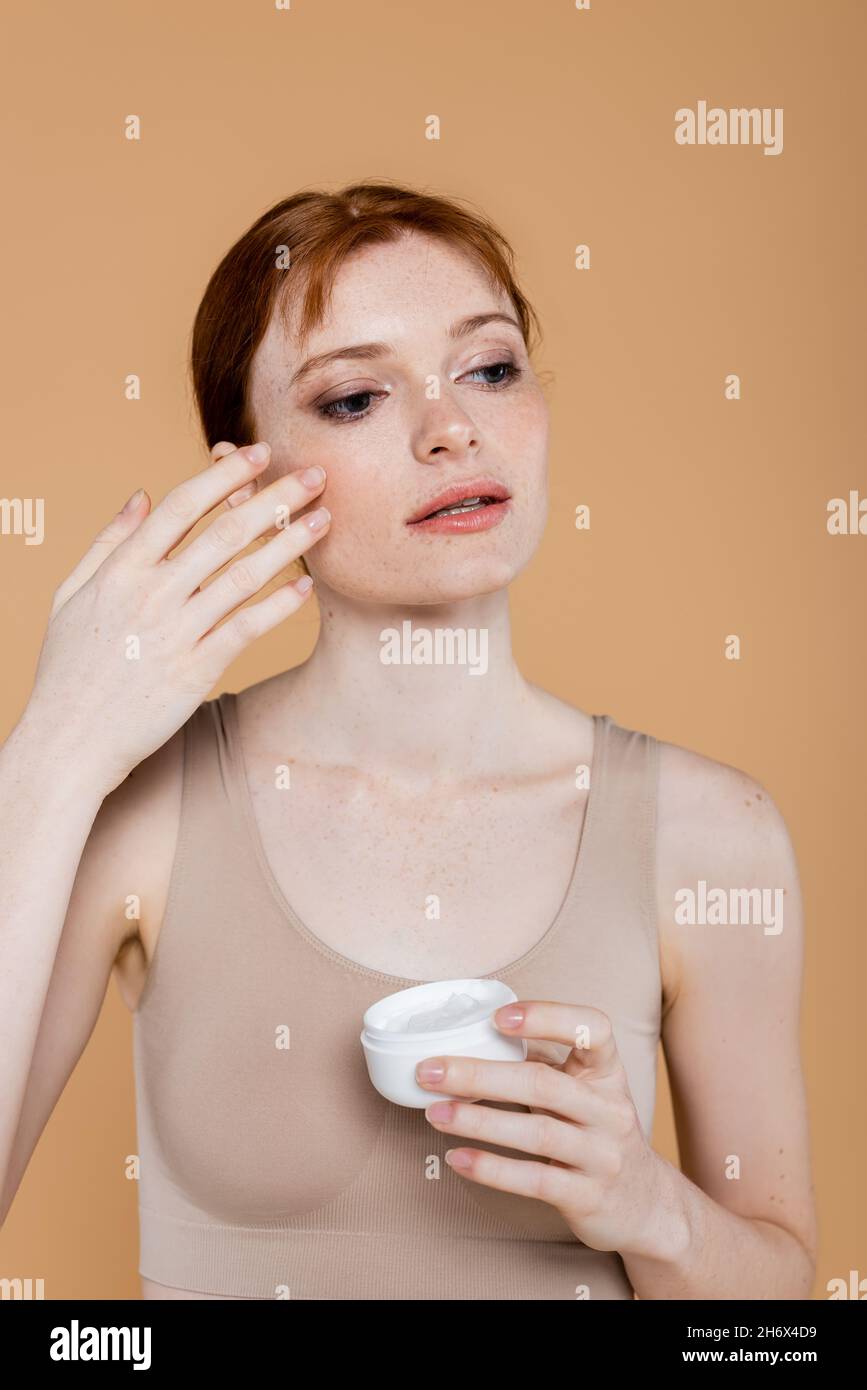 Woman freckles applying cream hi-res stock photography and images - Alamy