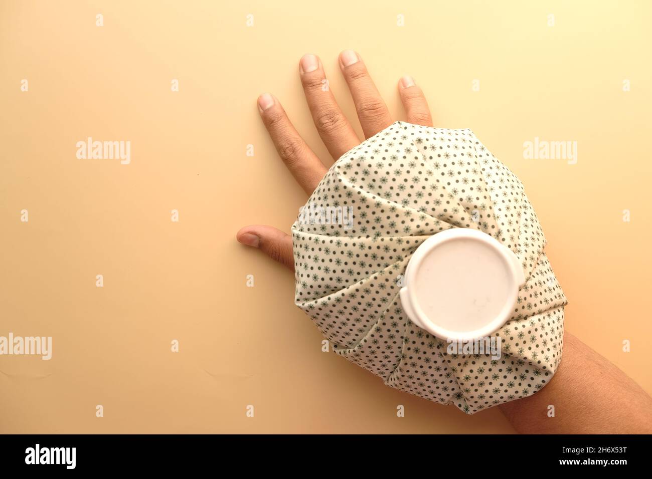 Young man hands suffering wrist pain, and applying cold water on injury
