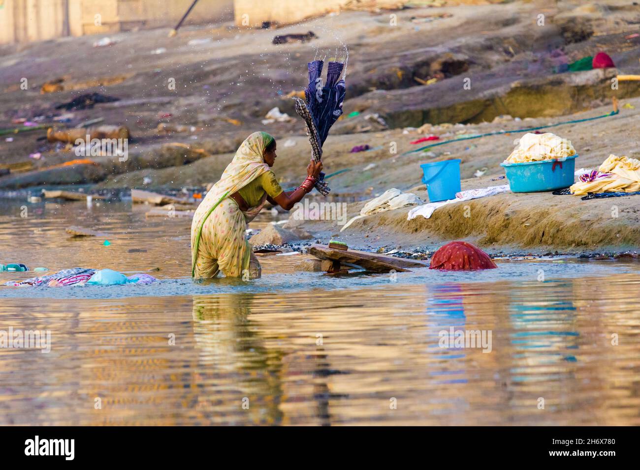VARANASI, UTTAR-PRADESH/INDIA - May 23, 2012: Women washing their saris and clothing in holy Ganga river Stock Photo