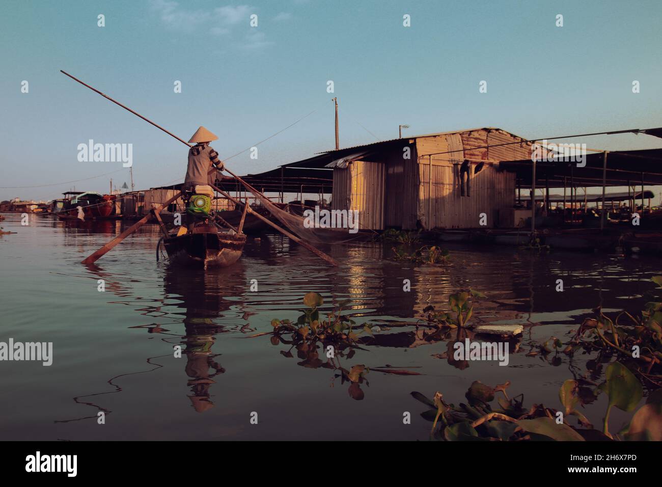 Rearview of a person in a boat paddling in along the waters showing the ...