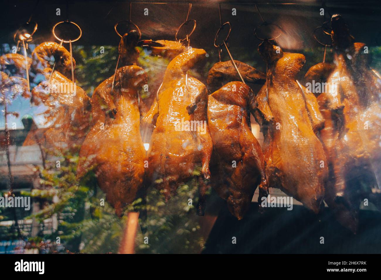 Famous vietnamese roasted ducks called Vit quay displayed behind a glass covered street food stall in Hanoi, Vietnam Stock Photo
