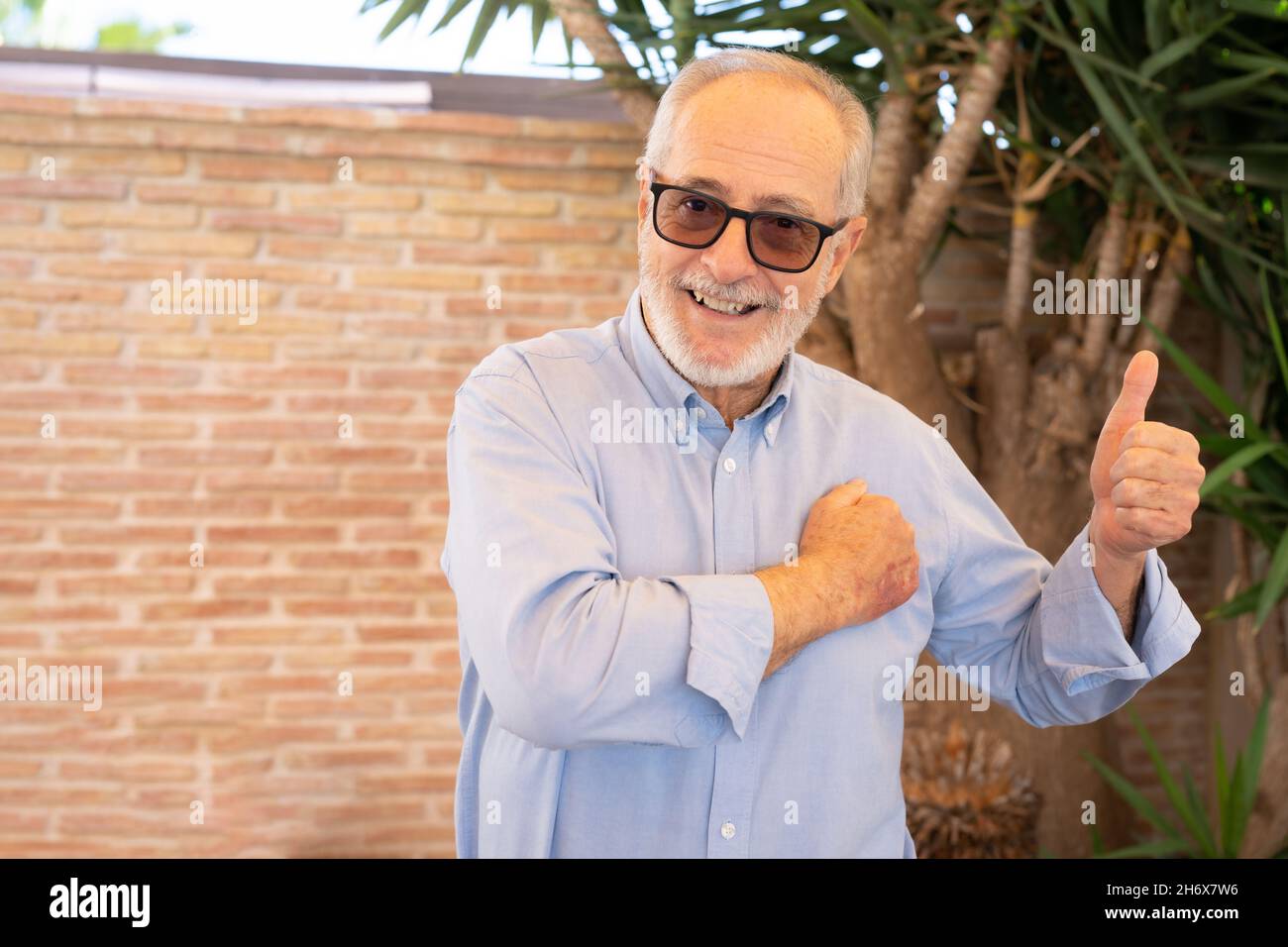 Happy senior man with thumb up outdoors Stock Photo - Alamy