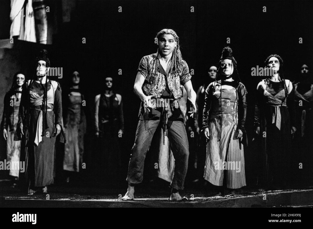 Thomas Randle (Dionysus) with women of Thebes in THE BACCHAE at English National Opera (ENO), London Coliseum, London WC2  05/05/1992 music: John Buller  text: William Arrowsmith  conductor: Martin Andre  set design: Hildegard Bechtler  costumes: Nicky Gillibrand  lighting: Alan Burrett  choreographer: Matthew Hamilton  director: Julia Hollander Stock Photo