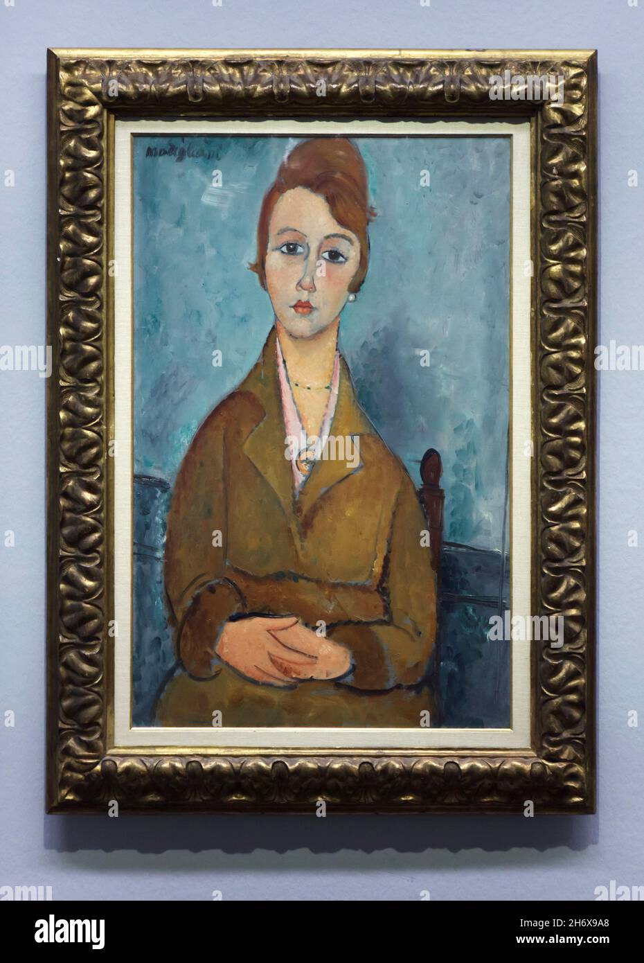 Painting 'Young Lolotte' by Italian modernist painter Amedeo Modigliani (1918) on display at his retrospective exhibition in the Albertina Museum in Vienna, Austria. The exhibition marking the centenary of artist's death runs till 9 January 2022. Stock Photo