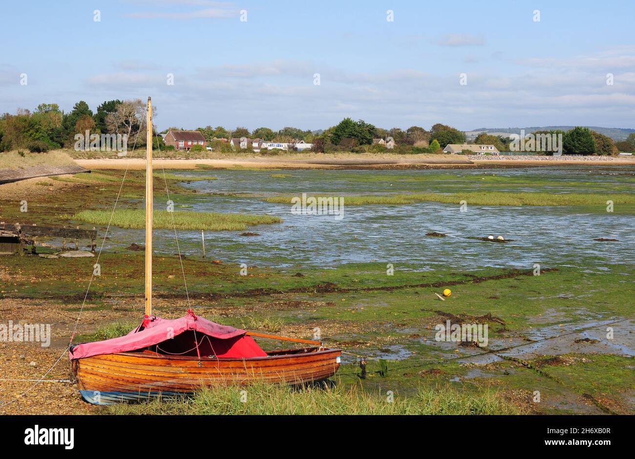 Moored dinghy at low tide, Prinsted. Stock Photo