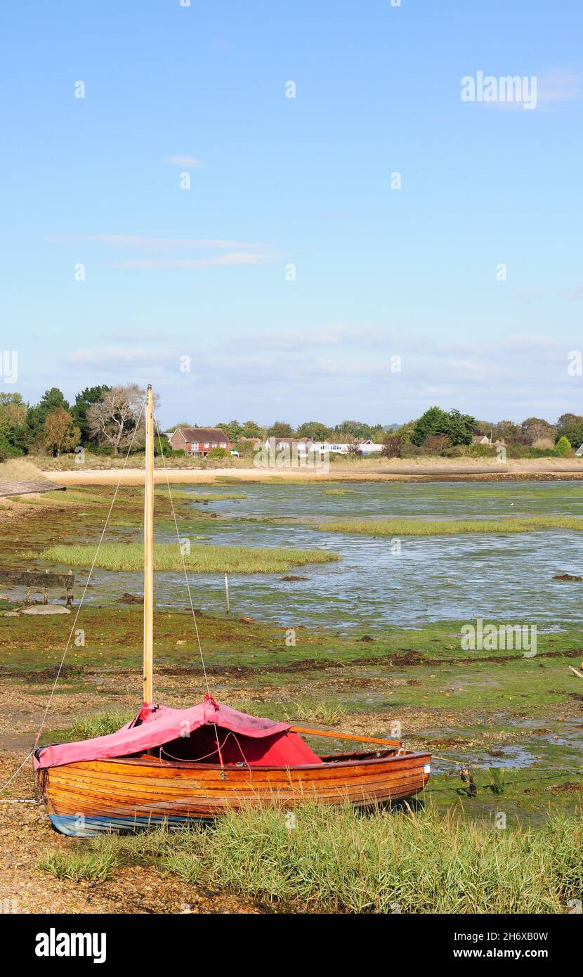 Moored dinghy at low tide, Prinstead. Stock Photo