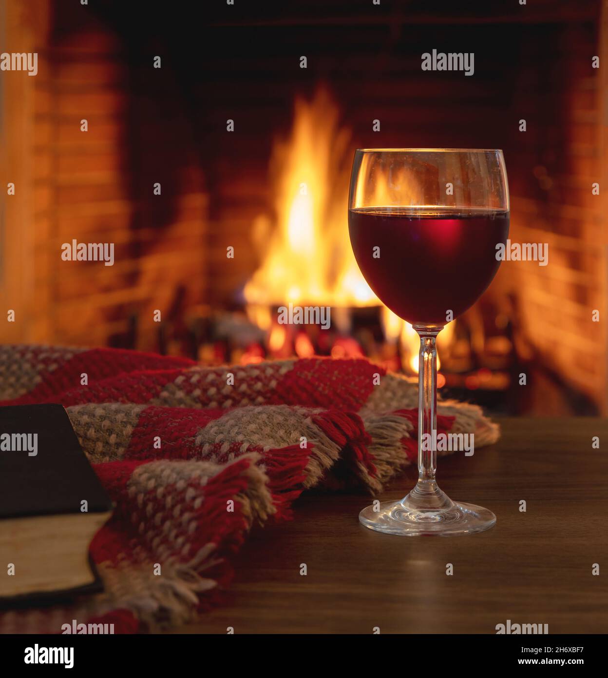 https://c8.alamy.com/comp/2H6XBF7/red-wine-glass-against-burning-fireplace-background-winter-holidays-relaxation-cozy-warm-home-interior-2H6XBF7.jpg
