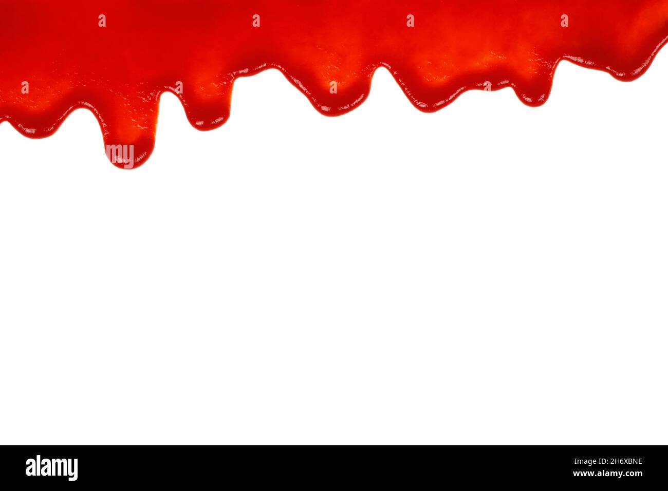 Red ketchup dripping on white background close-up Stock Photo