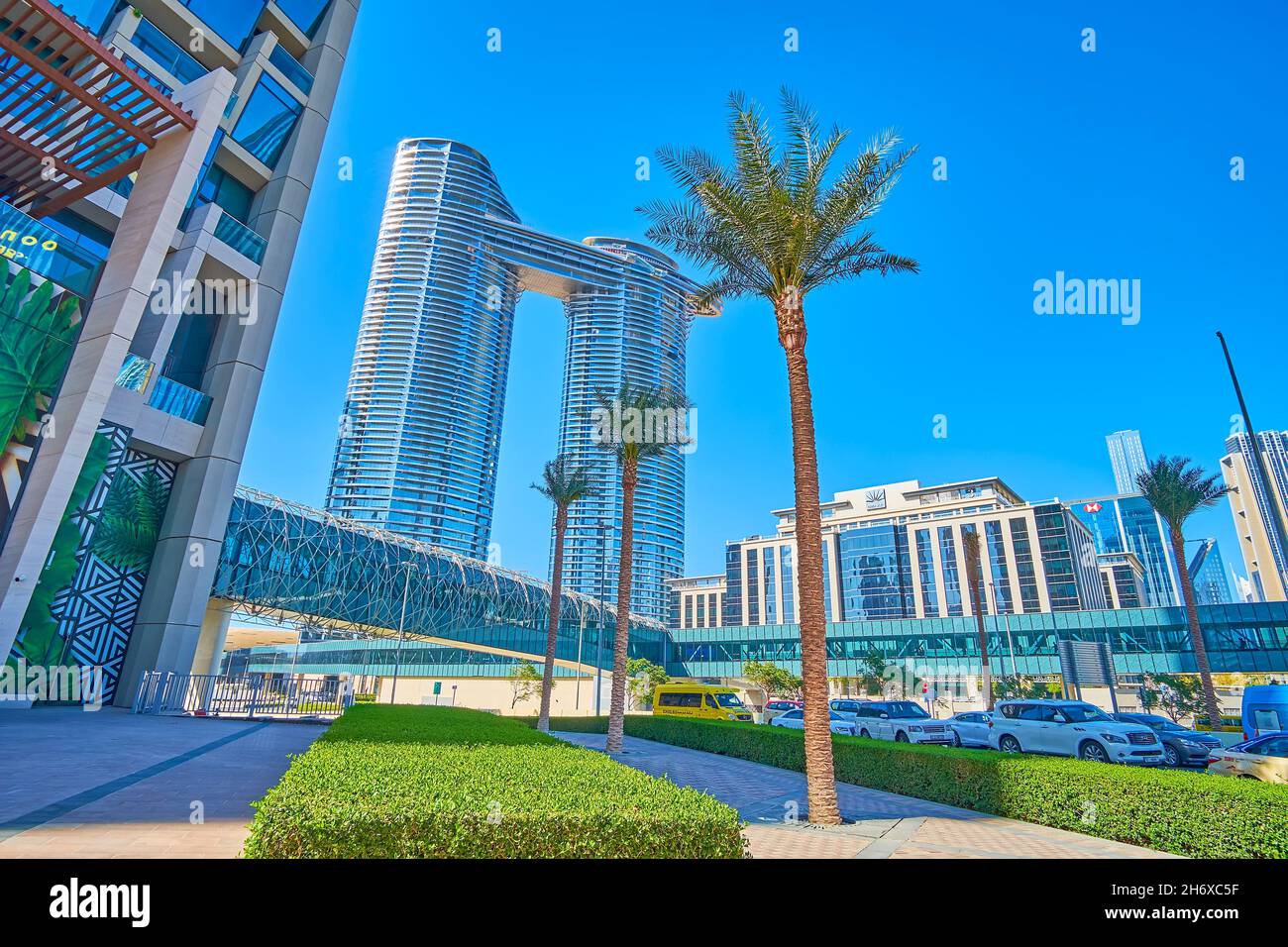 DUBAI, UAE - MARCH 3, 2020: The sunny palm alley along Sheikh Mohammed Bin Rashid Blvd, lined with modern glass skyscraper Address Sky View of Dubai D Stock Photo
