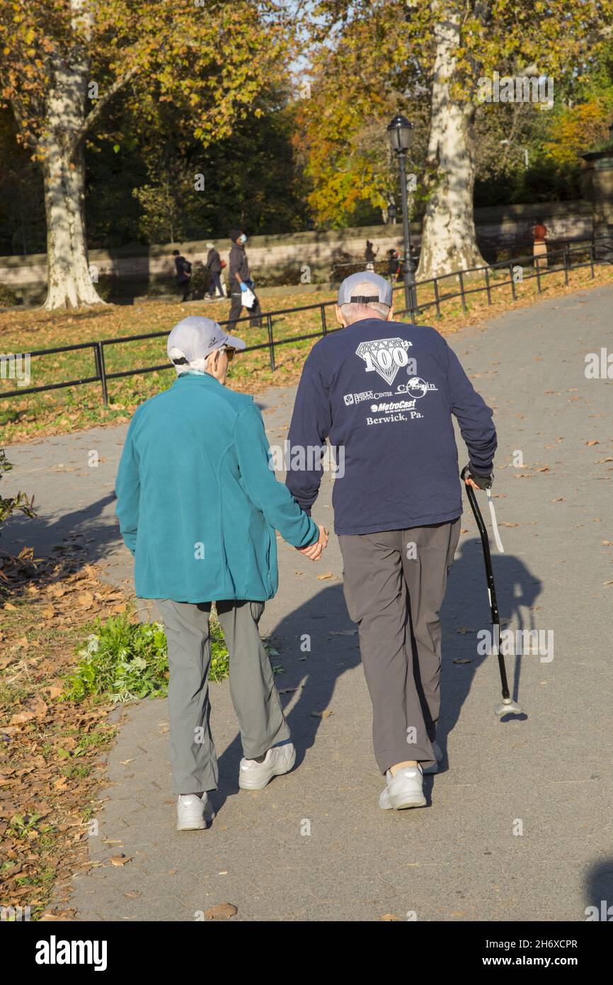 Elderly couple enjoy a walk on a sunny autumn day at Prospect Park, Brooklyn, New York. Stock Photo